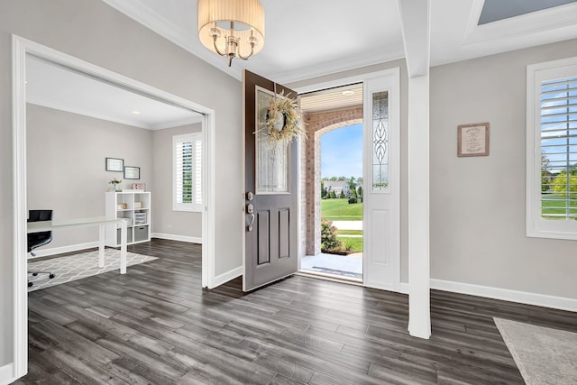 entrance foyer featuring dark wood-type flooring and crown molding