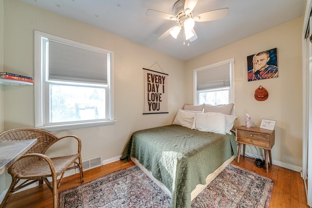 bedroom with ceiling fan and hardwood / wood-style floors