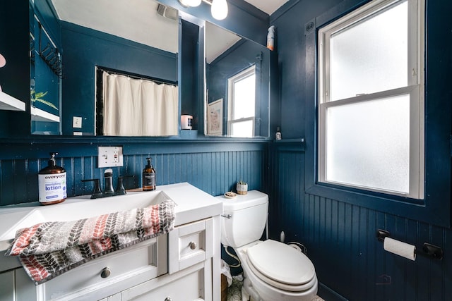 bathroom featuring toilet and vanity