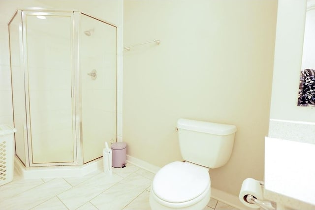 full bath with a stall shower, baseboards, and toilet