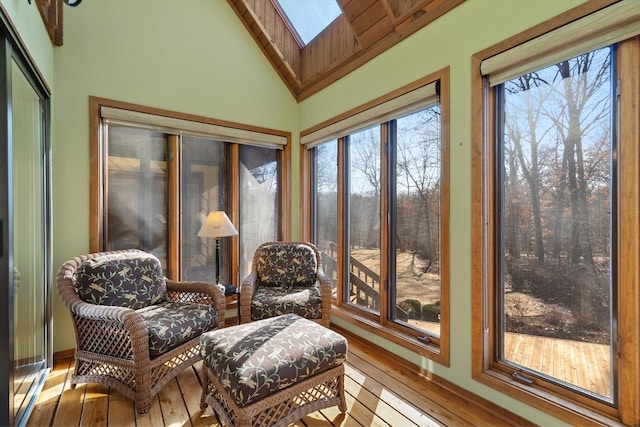 sunroom / solarium with vaulted ceiling with skylight