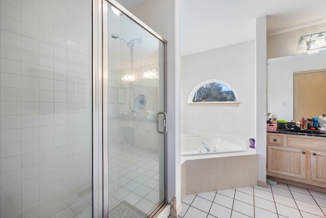 bathroom featuring independent shower and bath, vanity, and tile patterned flooring