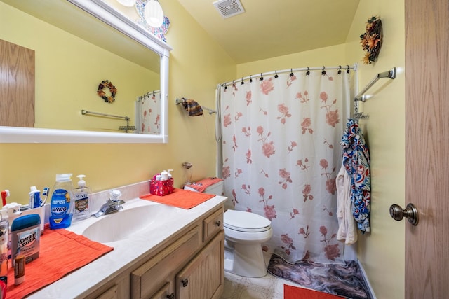 bathroom with vanity, toilet, and walk in shower