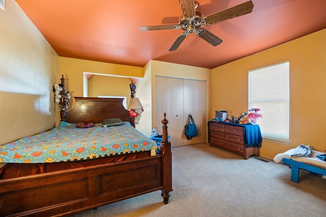 carpeted bedroom featuring a closet and ceiling fan