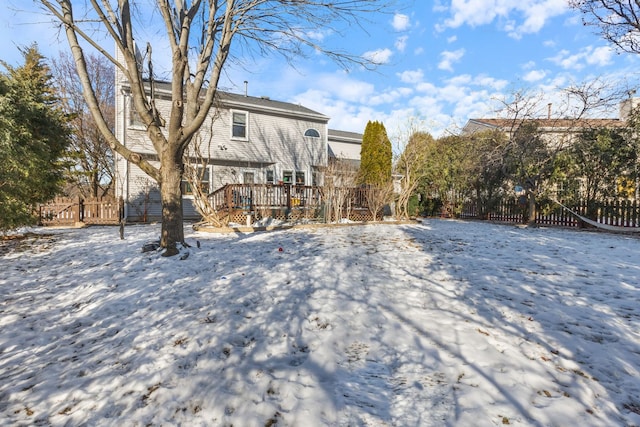 snow covered house featuring a deck