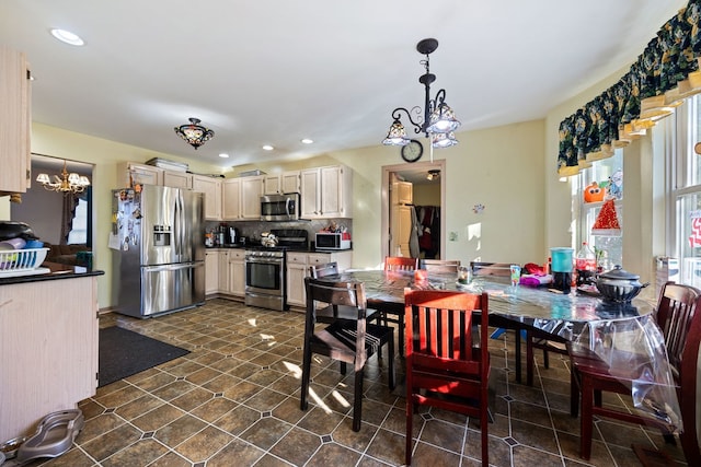 dining space featuring a notable chandelier