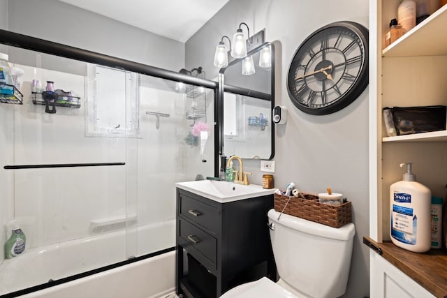 full bathroom featuring toilet, enclosed tub / shower combo, and vanity