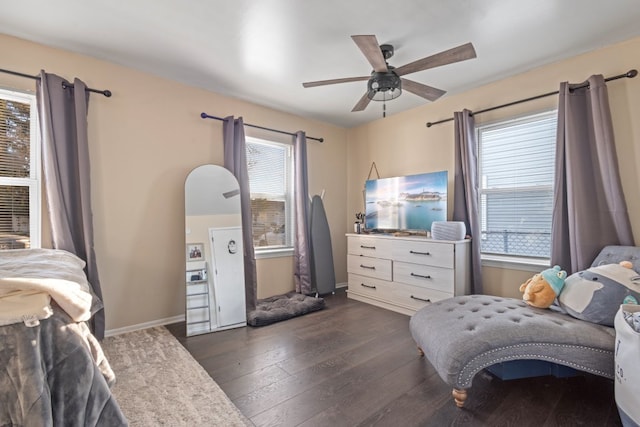 bedroom with dark wood-type flooring, ceiling fan, and multiple windows