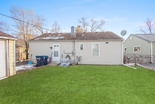 rear view of property with a lawn