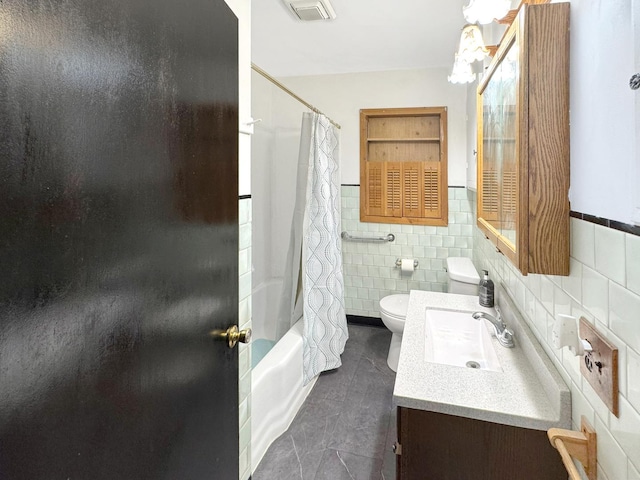 full bathroom featuring tile patterned floors, vanity, shower / bath combination with curtain, tile walls, and toilet