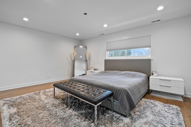 bedroom with hardwood / wood-style floors