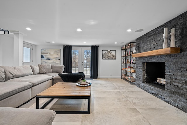 living room with french doors and a stone fireplace