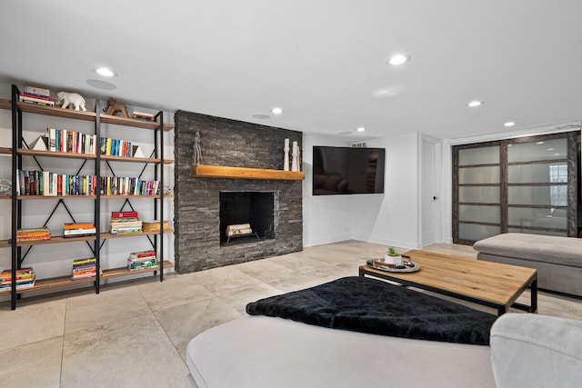 living room with a stone fireplace