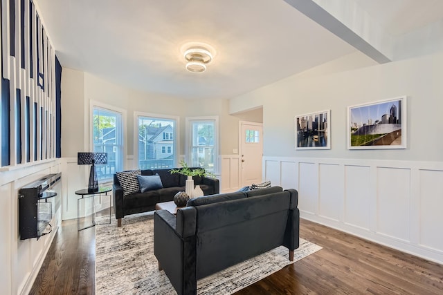 living room featuring beamed ceiling and hardwood / wood-style floors