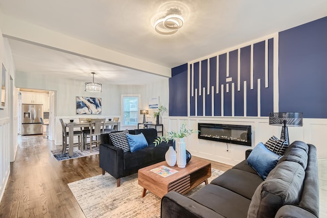 living room with a chandelier and hardwood / wood-style floors