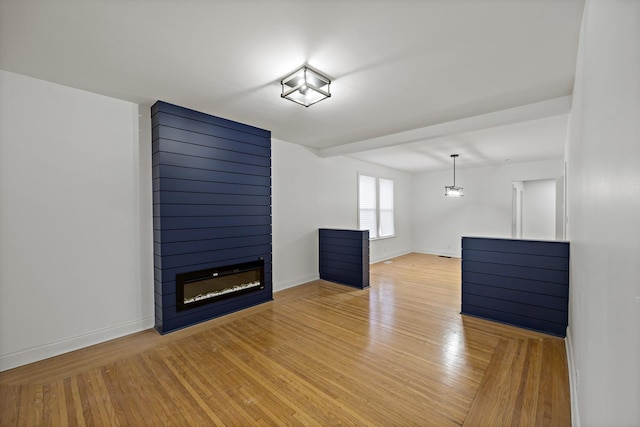 unfurnished living room with light wood-type flooring and a fireplace