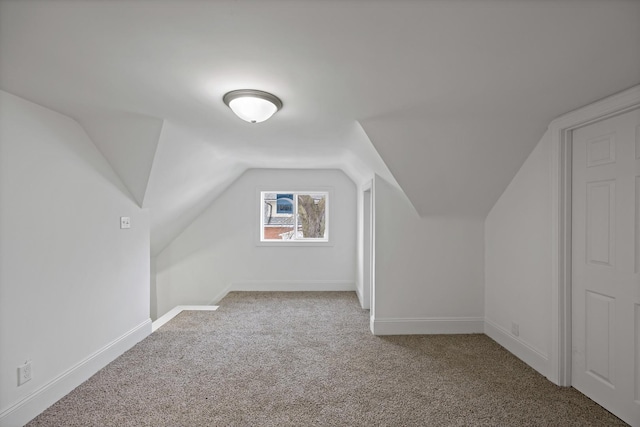 bonus room featuring light carpet and vaulted ceiling