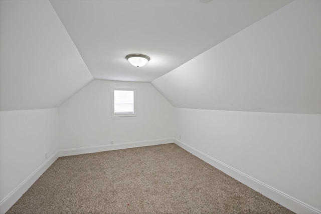 bonus room featuring lofted ceiling and carpet flooring