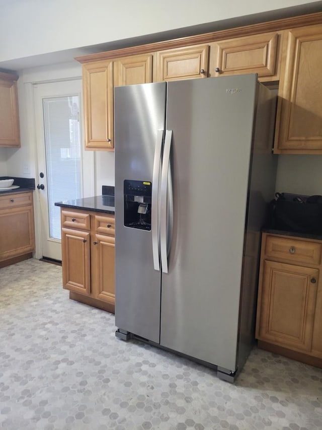 kitchen featuring stainless steel refrigerator with ice dispenser