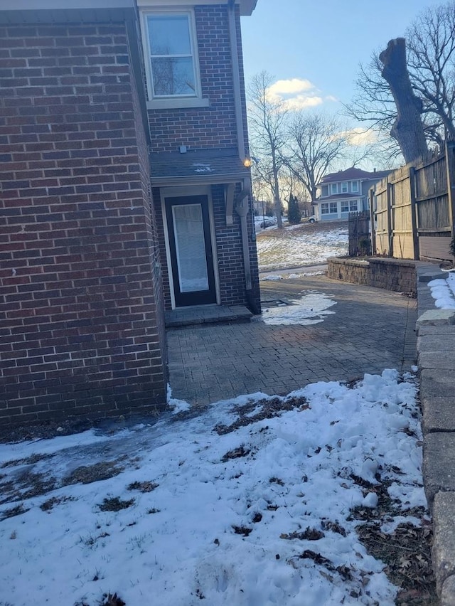 view of snow covered property entrance