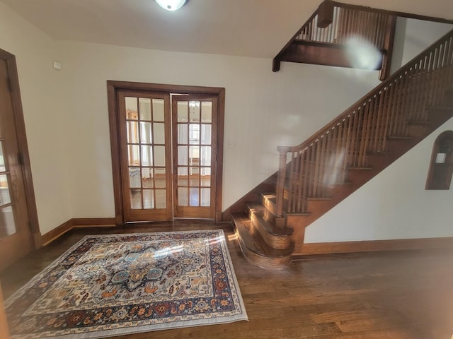 foyer entrance featuring french doors and dark wood-type flooring