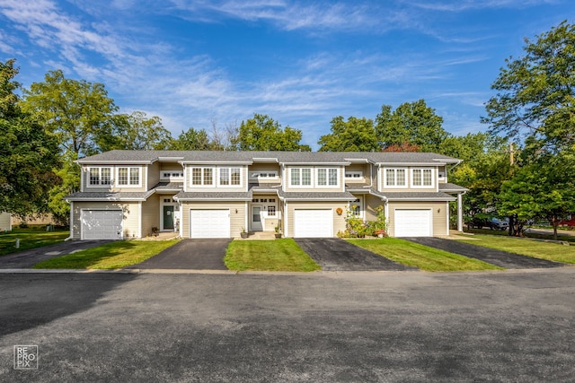 view of front of house featuring a garage and a front lawn