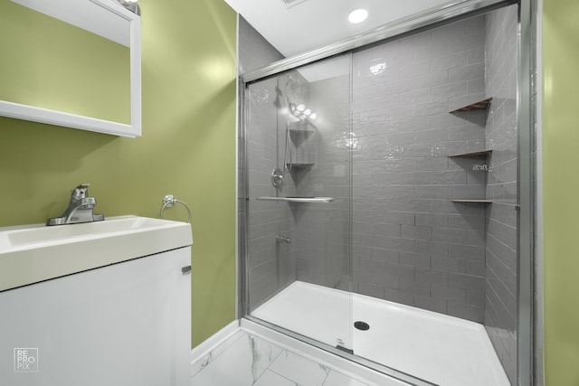 bathroom with vanity and a shower with door