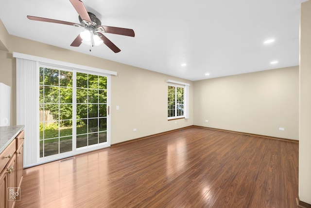 unfurnished living room featuring wood-type flooring and ceiling fan