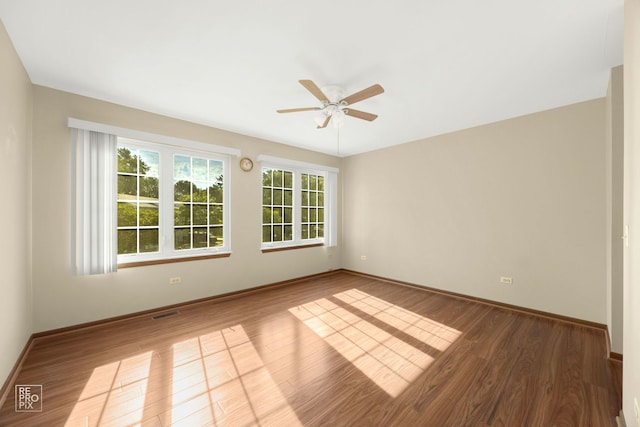 unfurnished room featuring ceiling fan and dark hardwood / wood-style flooring