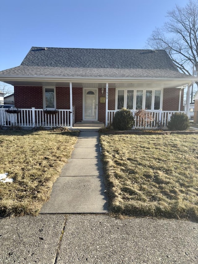 view of front of property with a porch and a front lawn