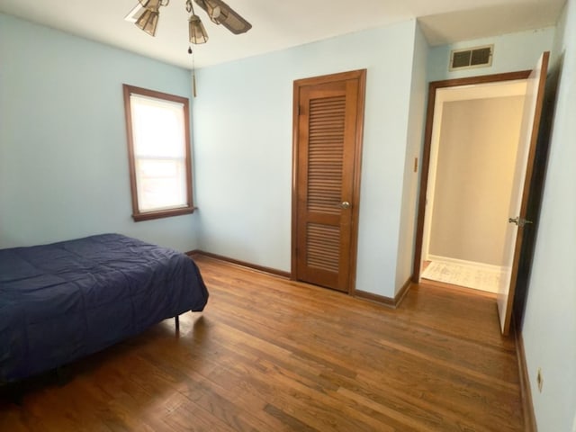 bedroom featuring ceiling fan and dark hardwood / wood-style flooring