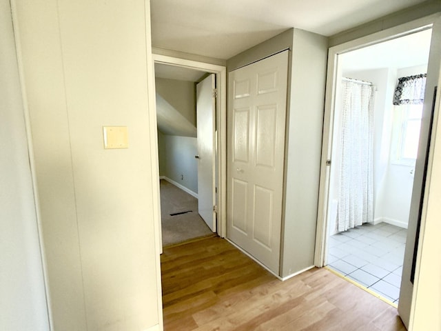 corridor with light hardwood / wood-style flooring