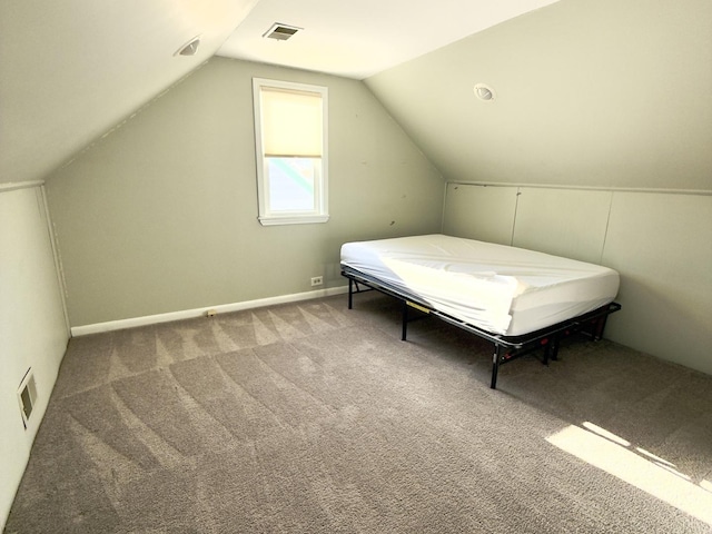 unfurnished bedroom featuring lofted ceiling and carpet floors