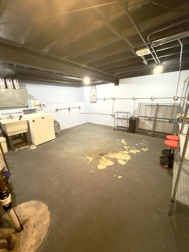 basement with washer / clothes dryer, sink, and electric panel