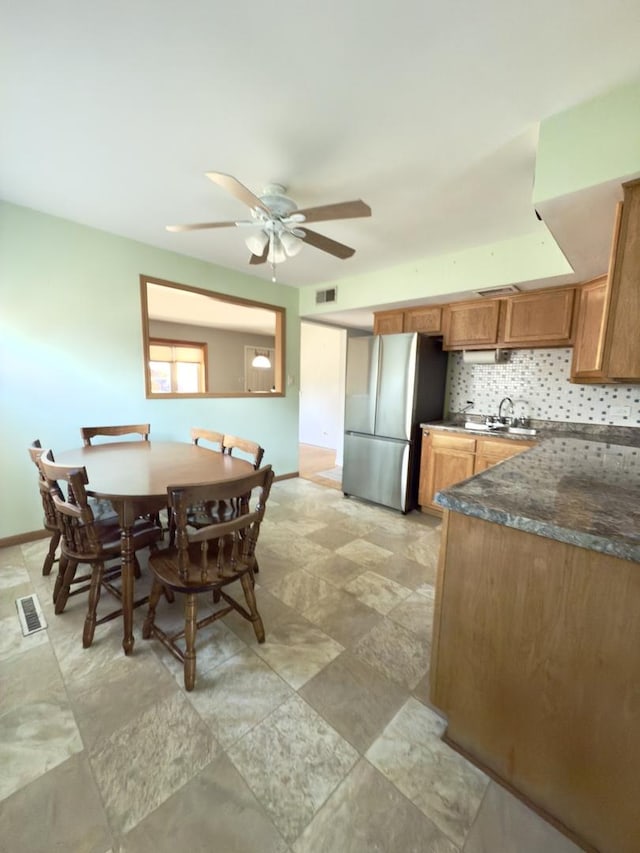 dining area featuring ceiling fan and sink