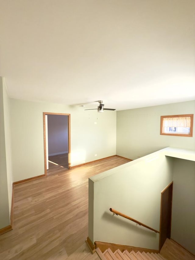 staircase featuring hardwood / wood-style floors and ceiling fan