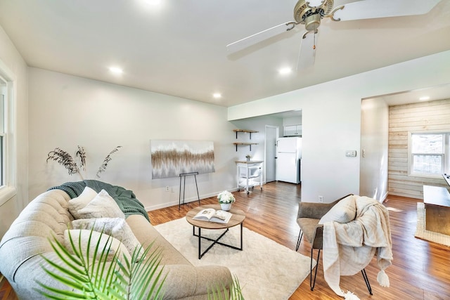 living room featuring hardwood / wood-style flooring and ceiling fan