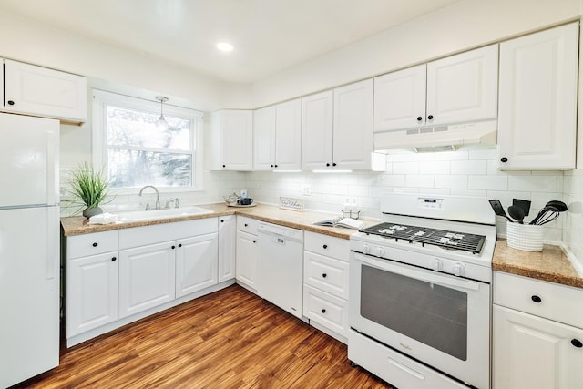 kitchen featuring wood-type flooring, decorative backsplash, sink, white appliances, and white cabinets