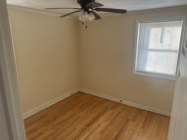 empty room featuring ceiling fan, ornamental molding, and light hardwood / wood-style flooring