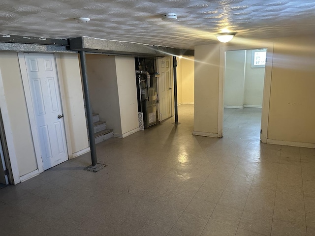 basement with heating unit and a textured ceiling