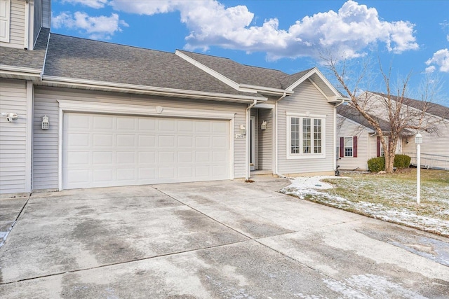 ranch-style house with a shingled roof, driveway, and an attached garage