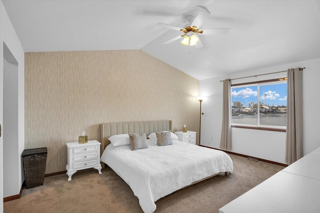 bedroom featuring lofted ceiling, baseboards, carpet, and wallpapered walls