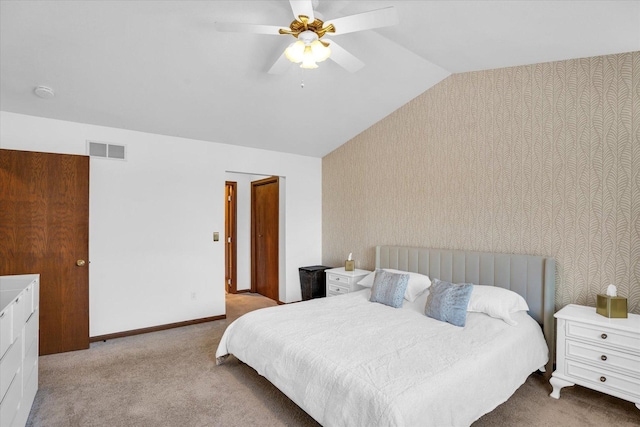 carpeted bedroom featuring wallpapered walls, baseboards, visible vents, a ceiling fan, and vaulted ceiling