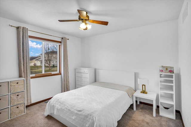 carpeted bedroom with a ceiling fan and baseboards