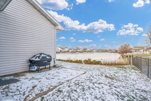 view of yard featuring a water view and fence