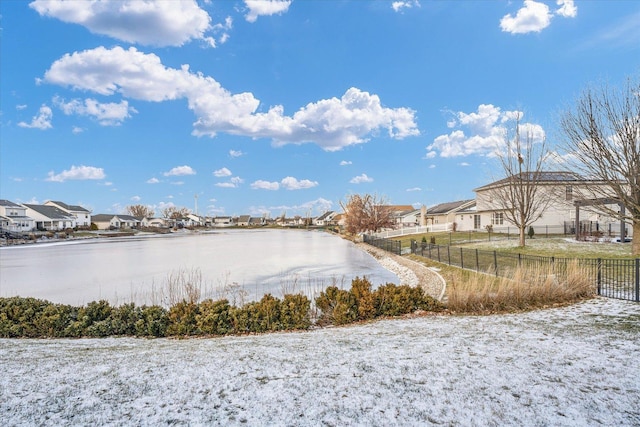 property view of water with a residential view and fence