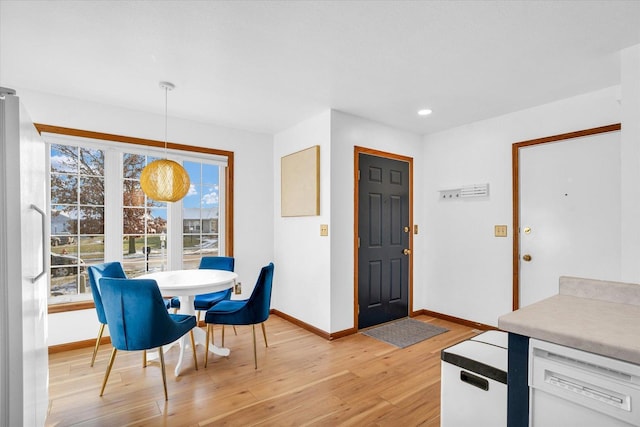 dining area with light wood-type flooring, baseboards, and recessed lighting