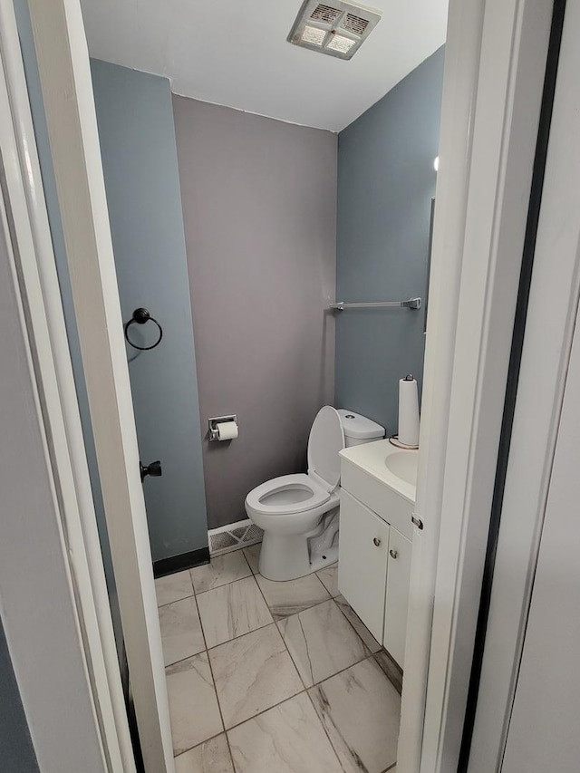 bathroom featuring toilet and vanity