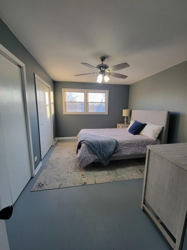 bedroom featuring ceiling fan and multiple closets