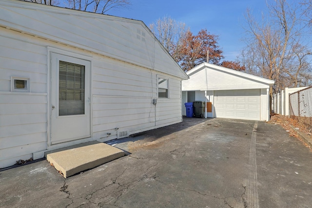 view of home's exterior with a garage and an outdoor structure